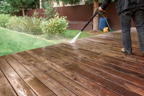 Man cleaning walls and floor with high pressure power washer. Washing terrace wood planks and cladding walls. High quality 4k footage